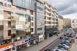a city street with cars parked next to tall buildings at Luxury 2BR Apartment - Old Town Bratislava Center in Bratislava