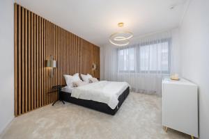 a bedroom with a bed and a large window at Luxury 2BR Apartment - Old Town Bratislava Center in Bratislava