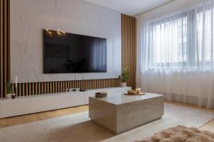 a living room with a large tv on the wall at Luxury 2BR Apartment - Old Town Bratislava Center in Bratislava
