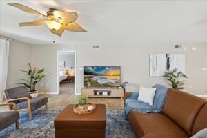 a living room with a couch and a ceiling fan at Shorewood 401 in Cape Canaveral