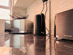 a microwave sitting on top of a glass table at Windermere Sands in Gqeberha +34 photos
