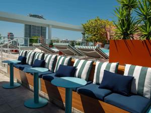 a row of chairs and tables on a balcony at Novotel Miami Brickell in Miami +136 photos