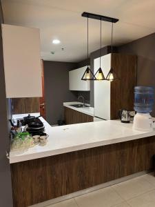 a kitchen with a white counter top in a room at Luxury one bed Apartment in Gold Crest Mall And Residency DHA Lahore in Lahore +196 photos