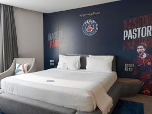 a bedroom with a large bed with a football wall at Novotel Jakarta Cikini in Jakarta +97 photos