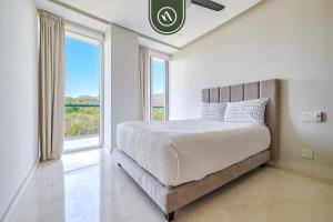 a bedroom with a bed and a large window at Oceanview 2 BR Condo in Punta Mita - Beach - Pool in Higuera Blanca +61 photos