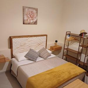 a bedroom with a bed with two pillows and a shelf at Civico18 in Fiumicino