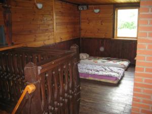 a room with a bed and a window in a cabin at Pie Ozola in Repši