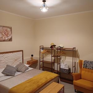a bedroom with a bed and a chair at Civico18 in Fiumicino