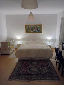 a bedroom with a bed and a rug at Dom przy lesie i jeziorze in Piece