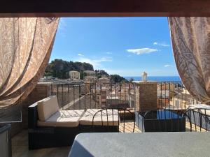 a room with a balcony with a view of the ocean at Adamas Domus in Taormina