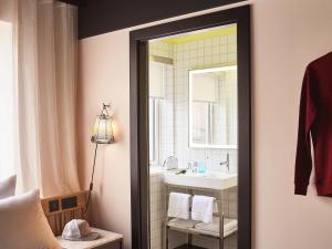 a bathroom with a sink and a mirror at Mama Shelter London - Shoreditch in London +141 photos