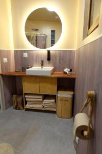 a bathroom with a sink and a mirror at Suite - Le Lotus de Conflans in Conflans-Sainte-Honorine