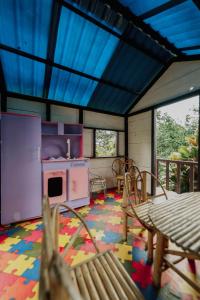 カラルカにあるFinca Hotel La Cabañitaのコンロ、テーブル、椅子が備わる客室です。