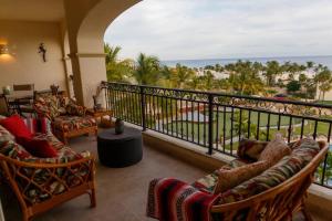 a balcony with couches and a view of the ocean at Las Mañanitas LM F4404 in San José del Cabo