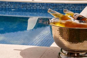 a bucket with beer bottles in it next to a pool at Hacienda La Tulia Eco Hotel in Toro +28 photos