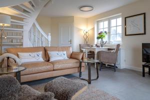 a living room with a couch and a table at Heefwai-Wohnung-4 in Morsum