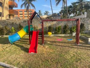 a playground with colorful slides and a swing at Apartamento con vista al mar in Tucacas