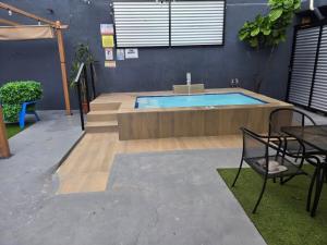 a pool in a room with a table and chairs at House with pool and close to everything in San Juan