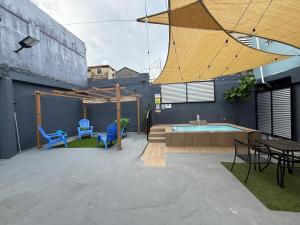 a patio with a table and chairs and a pool at House with pool and close to everything in San Juan