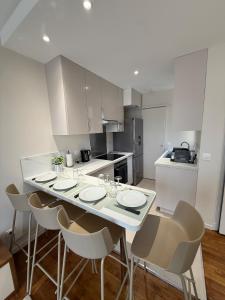 a kitchen with a table with chairs and a counter top at Superbe T2 in Orléans
