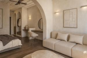 a living room with a couch and a bed at Tholaria Boutique Hotel in Astypalaia Town +84 photos