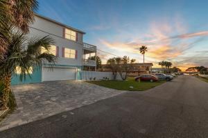 a house with a parking lot next to a street at HeatedPool HotTub 3min2Beach GameRm PetFriendly in Saint Augustine