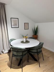 a white table with chairs and a vase of flowers on it at Modern Design Apartment Salona I Stylish & Comfortable Solin I Split in Solin