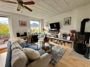 a living room with a couch and a fireplace at Mountain Vista Apartment in Bled