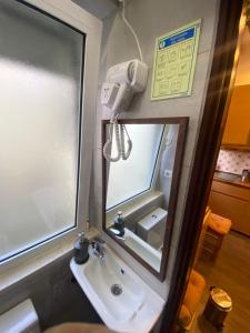 a bathroom with a sink and a mirror at Estudio T34 - City Historic center in Lisbon +35 photos