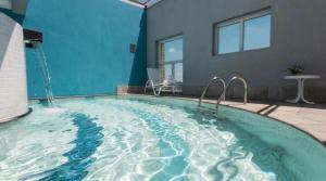 a swimming pool in a house with a blue wall at Hotel em Perdizes - FLAT1402 - By TorresGuest in São Paulo