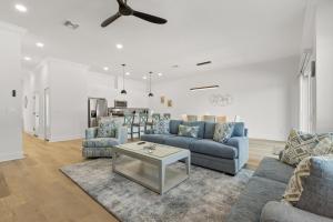 a living room with blue couches and a table at NEW Casa Cielo - Gorgeous Newly Built Tampa Home in Tampa