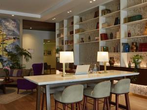 a conference room with a table with chairs and a laptop at Manto Hotel Lima - MGallery Collection in Lima