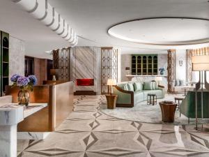 a living room with a couch and a table at The Silveri Hotel Hong Kong - MGallery Collection in Hong Kong