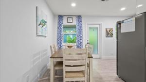 a dining room with a table and chairs at Ocean Drive Villas- Unit A in Fort Pierce Shores