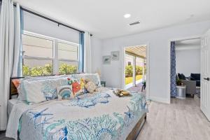a bedroom with a bed with a teddy bear on it at Ocean Drive Villas- Unit A in Fort Pierce Shores