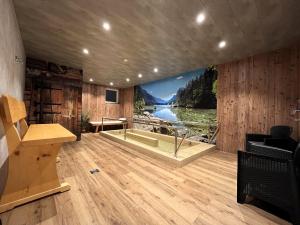 a room with a bathtub in the middle of a room at Waldgeflüster, Montana Haus in Oberstdorf