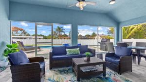 a living room with blue couches and a table at Gem of Jensen Beach in Jensen Beach
