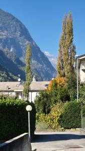a house with a mountain in the background at La casa delle margherite - Tirano in Tirano