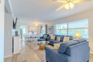 a living room with a blue couch and a table at Siesta Key Exclusive Beachside Compound 3 Units in Point O'Rocks