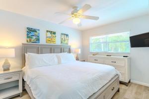 a bedroom with a white bed and a ceiling fan at 1010 Point of Rock in Point O'Rocks +25 photos