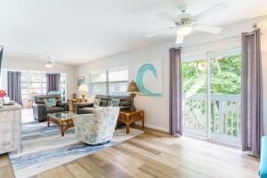 a living room with a couch and a ceiling fan at 1010 Point of Rock in Point O'Rocks