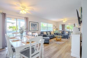 a dining room and living room with a table and chairs at 100' from the beach, Elegant 3BR Beach Retreat in Point O'Rocks