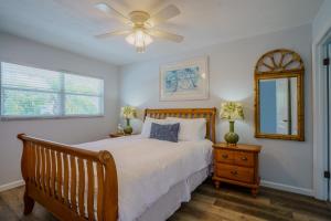 a bedroom with a bed and a ceiling fan at 100' from the beach, Elegant 3BR Beach Retreat in Point O'Rocks +30 photos