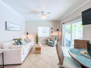 a living room with a couch and a table at 100' from the beach, Charming 1BR Beachside Retreat in Point O'Rocks