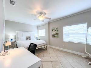 a bedroom with a bed and a ceiling fan at 100' from the beach, Charming 1BR Beachside Retreat in Point O'Rocks +26 photos