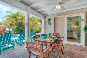 a patio with a wooden table and chairs at La Contento Casa - 5560 in Siesta Key