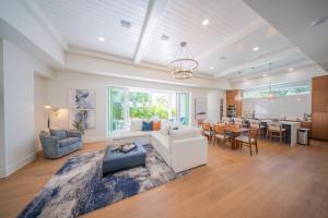 a living room with a couch and a table at New Contruction Modern Outdoor Oasis Prime Location in Southgate