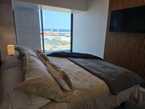 a bedroom with a bed with a view of the ocean at HOM I Ideal Depto 2D2B Frente al Mall Antofagasta in Antofagasta +64 photos