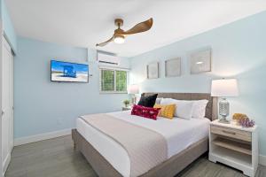 a bedroom with a bed and a ceiling fan at Sea Coast - 276 in Siesta Key