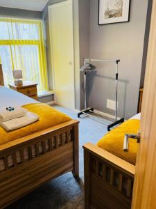 a bedroom with two beds and a lamp in it at Gaen - Ty Seren in Abertillery